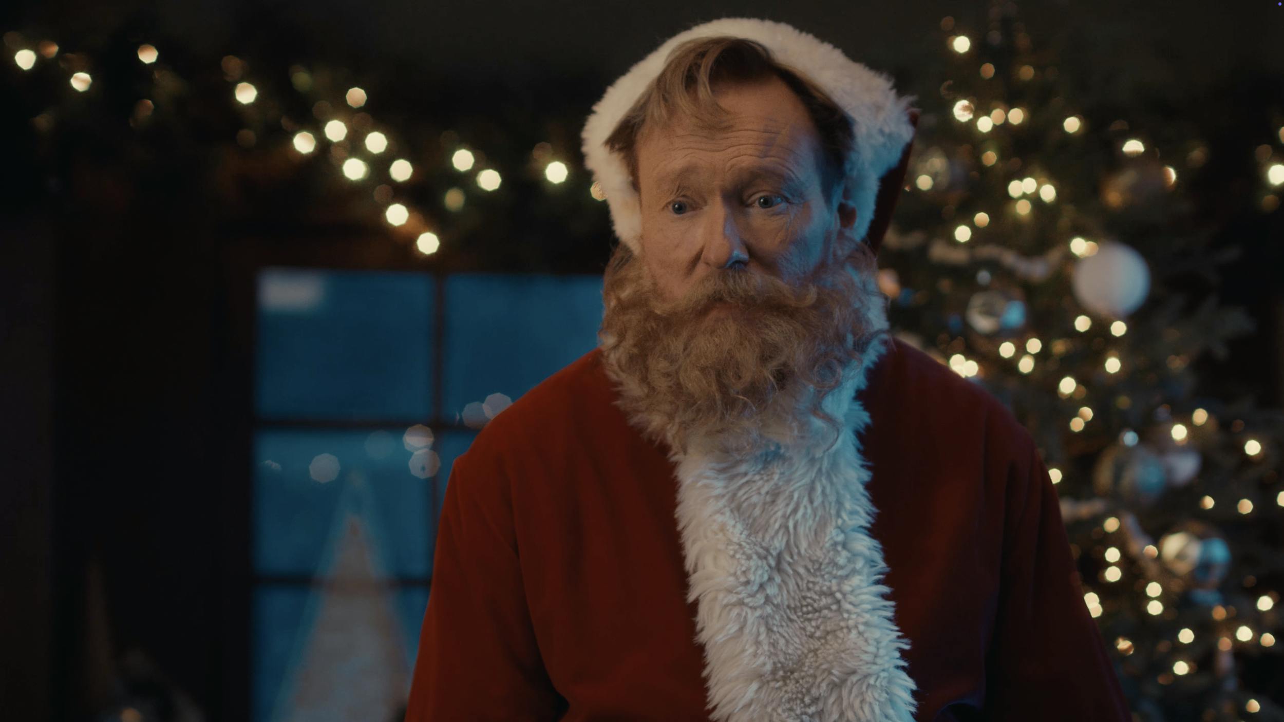 Man dressed as Santa Claus in festive setting, representing holiday storytelling and cinematic video production scenes