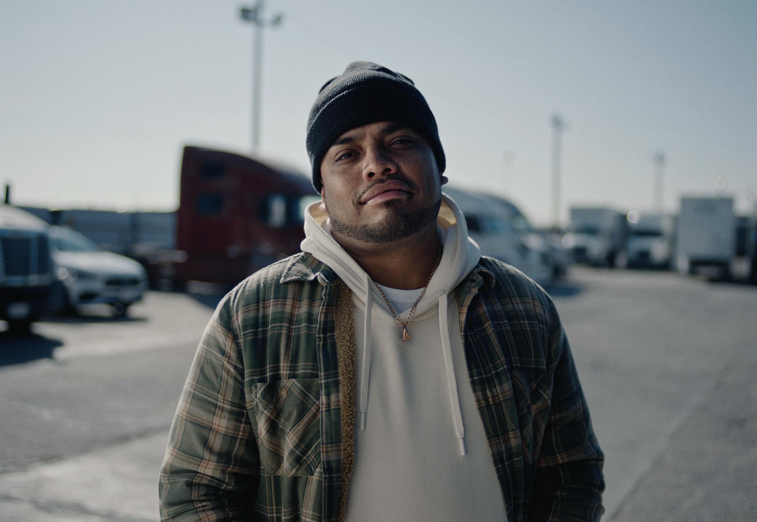 Man standing outdoors in casual outfit, representing lifestyle storytelling and real-world character scenes in professional video production