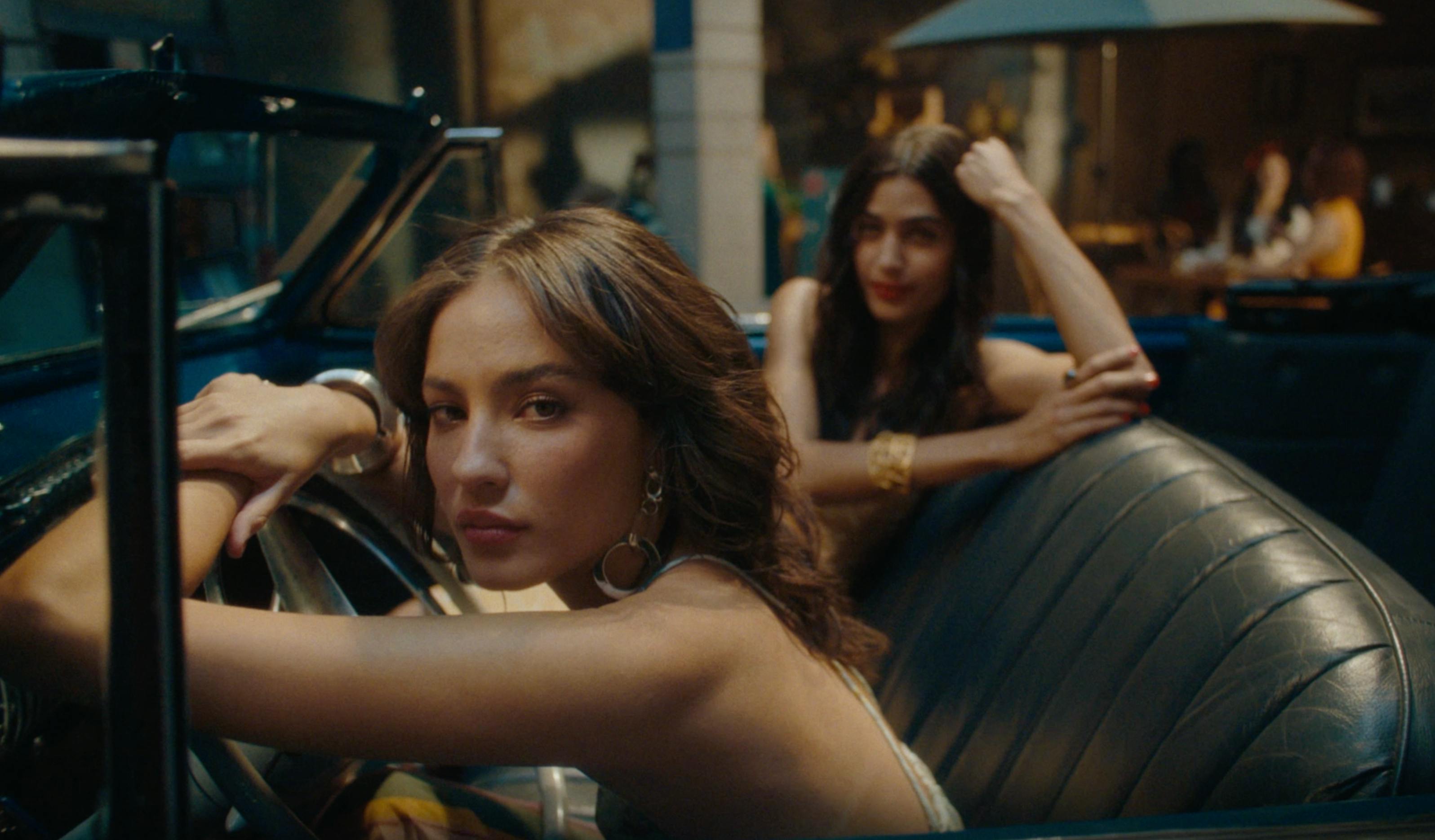 A cinematic shot of a women looking over her shoulder.