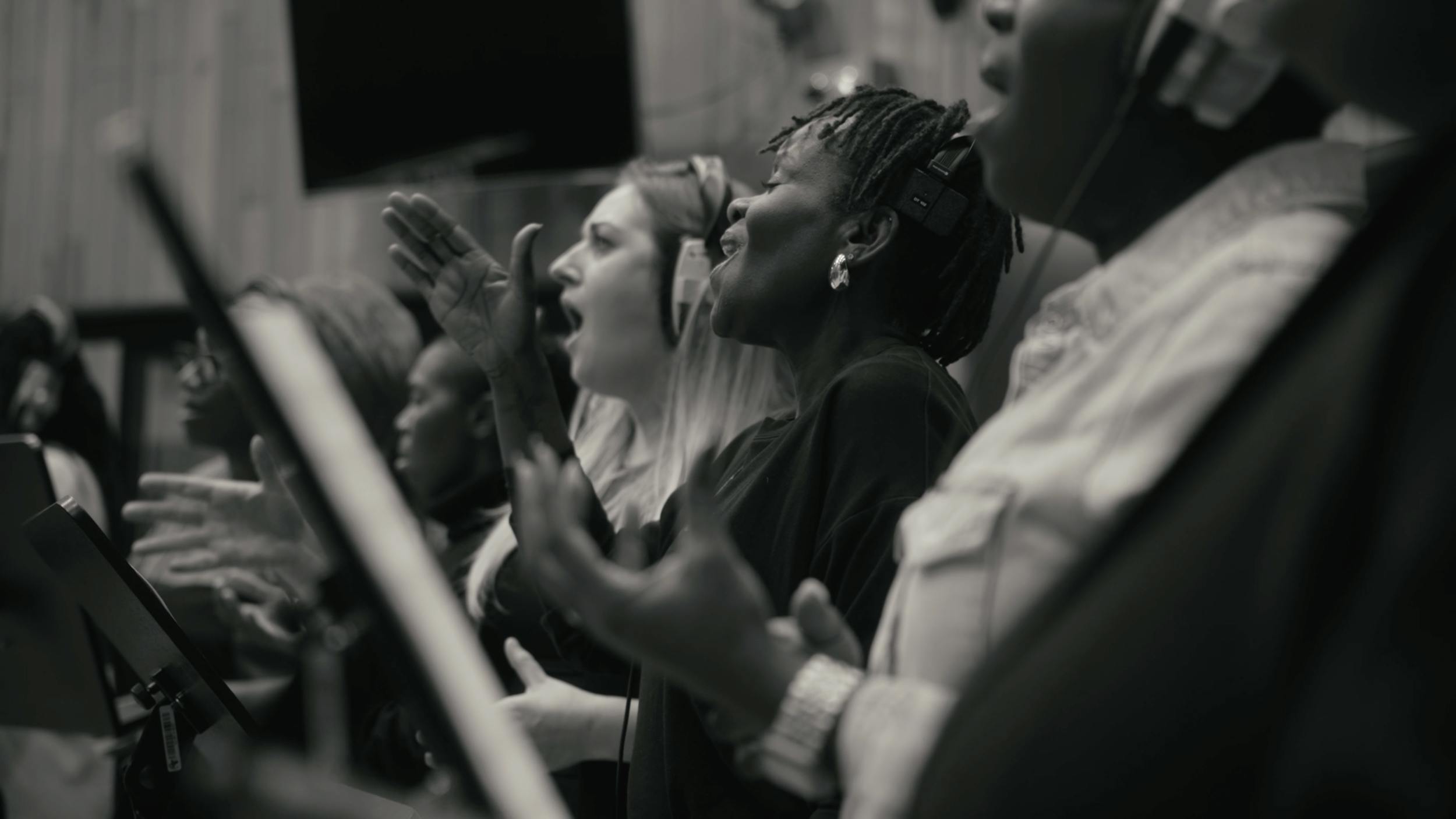 Choir group passionately singing together, representing emotion, performance, and collective human expression.