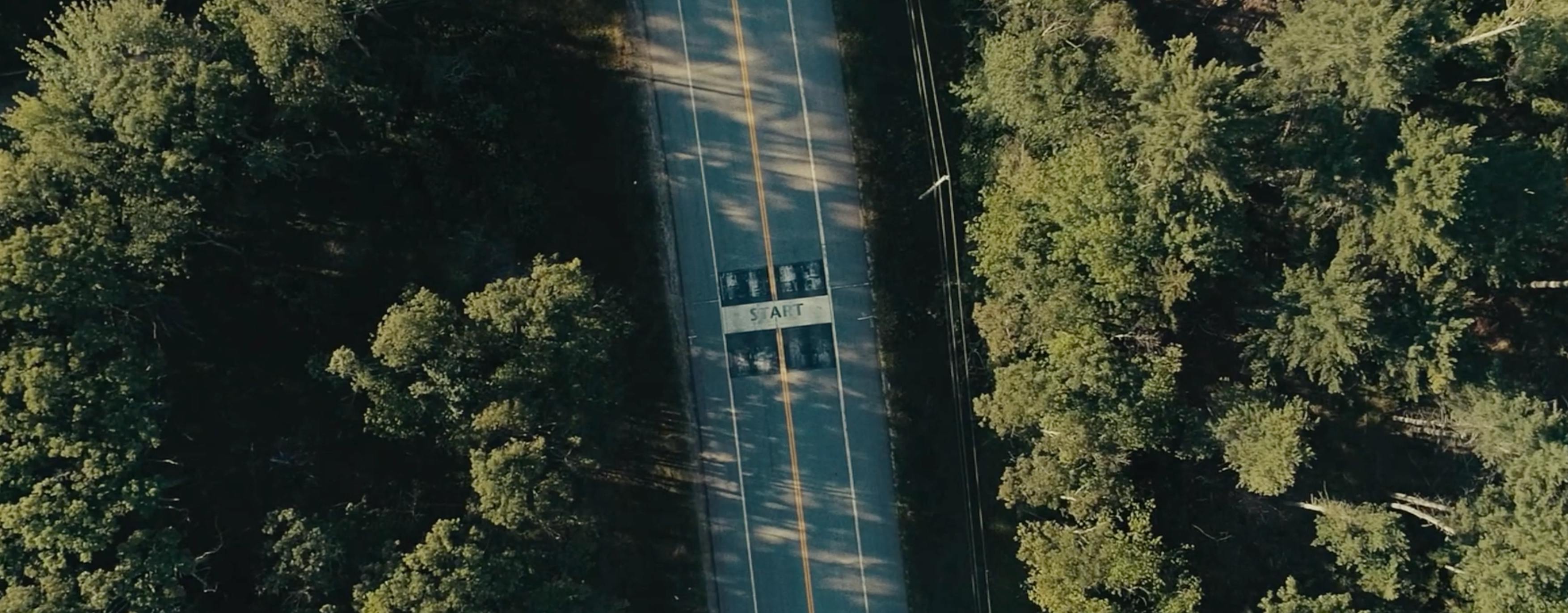 The thumbnail shows an overhead, high-angle drone shot of a road or bridge stretching through a natural landscape.