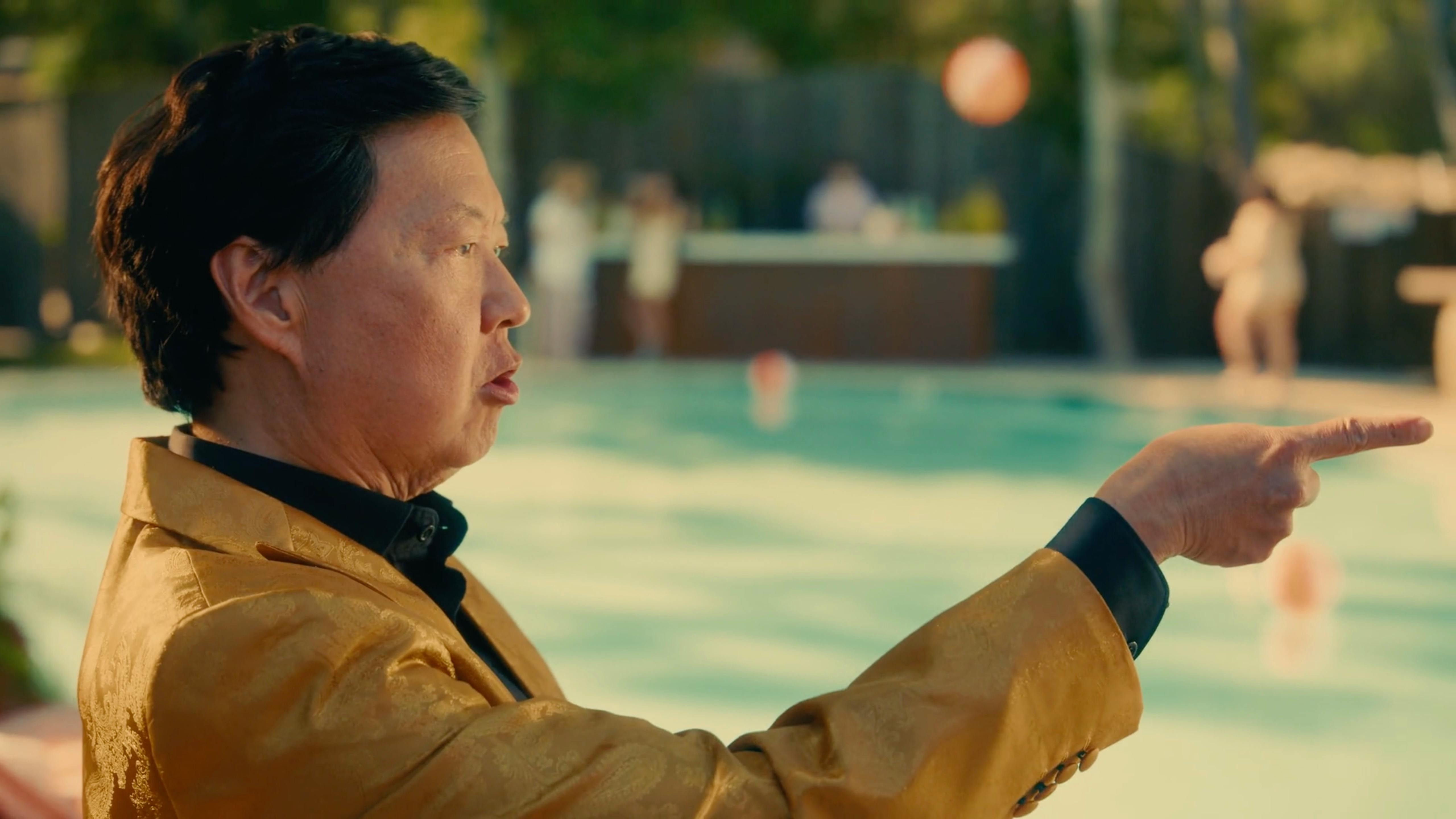 Actor in gold suit pointing during a dramatic shoot by a video production company NYC producing series content