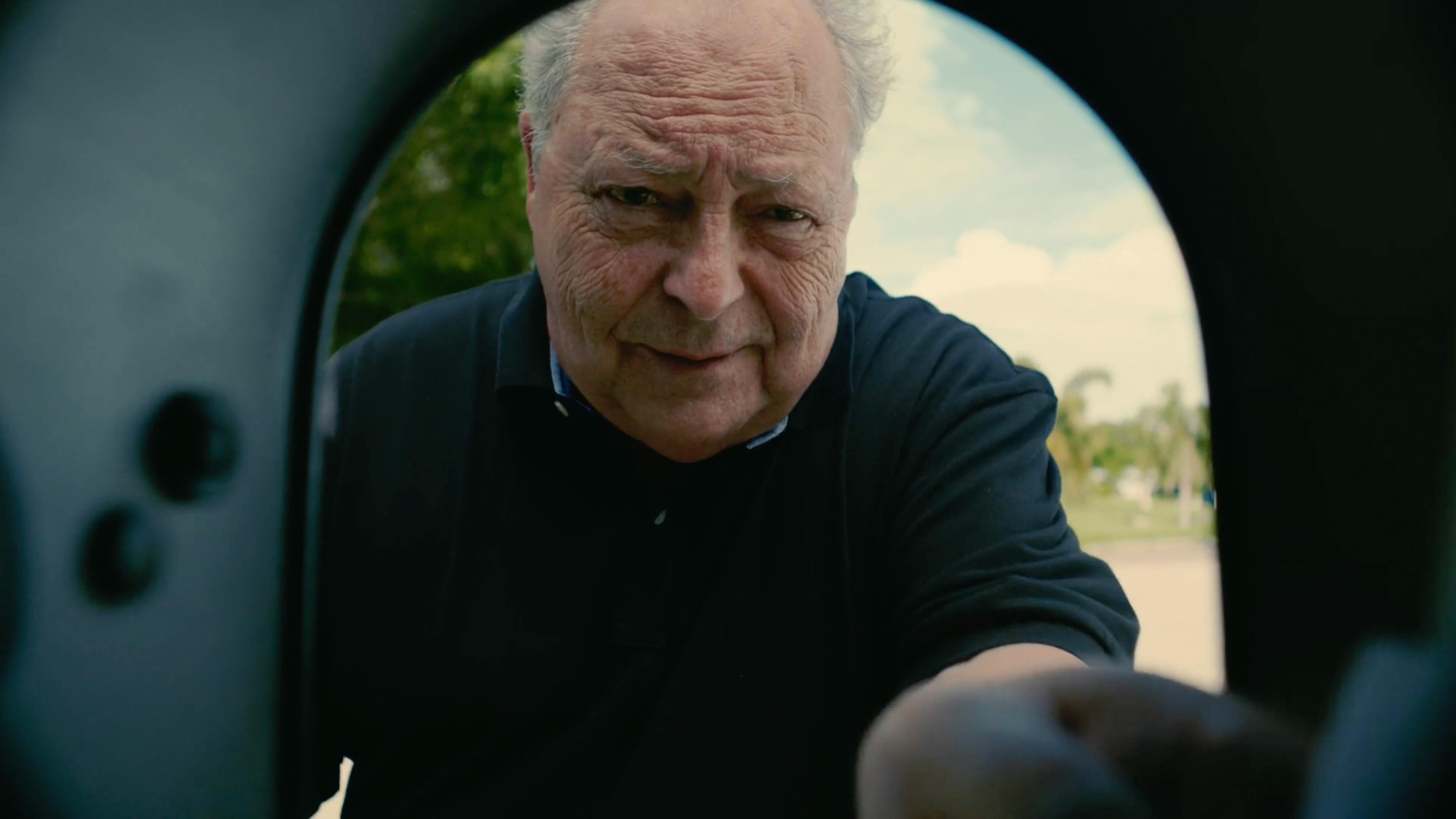 Dramatic cinematic close-up of an older man through a circular frame, by a TV commercial production company for high-impact video production services