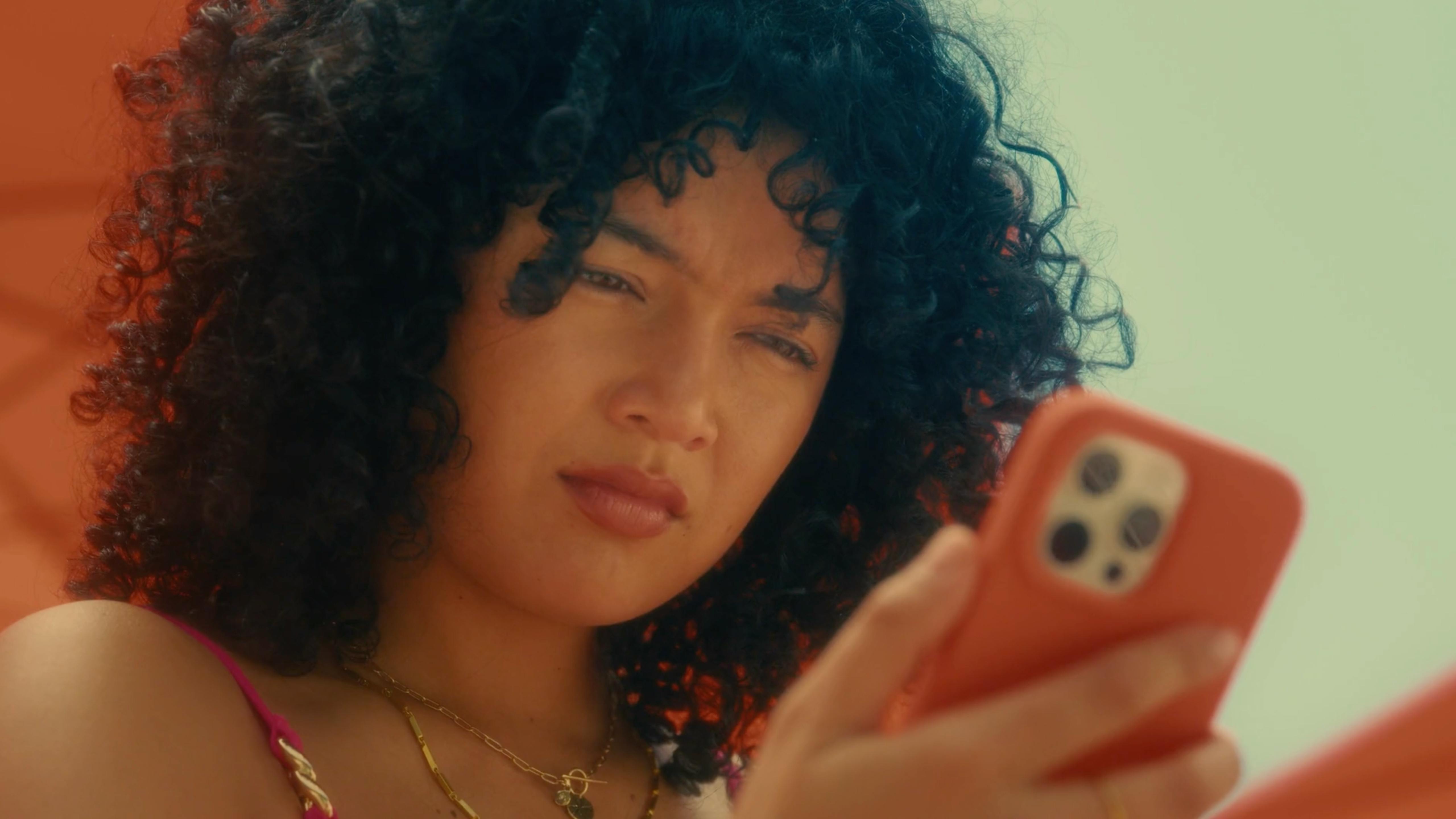 Woman checking phone in a lifestyle ad created by a creative video production agency in USA for social media video production