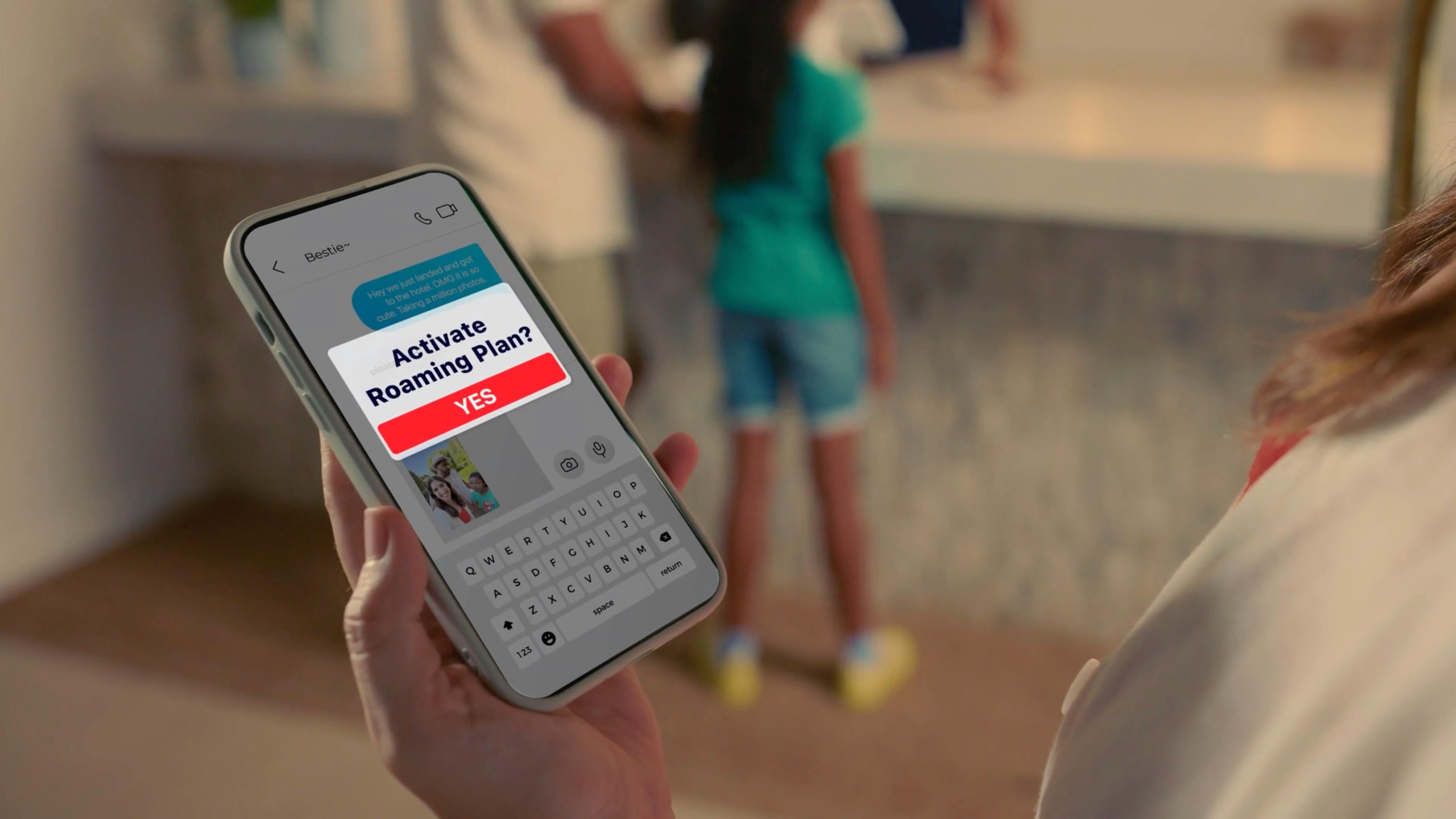 Hand holding a smartphone with a child in the background, shot by a full service video production company for video marketing for small businesses
