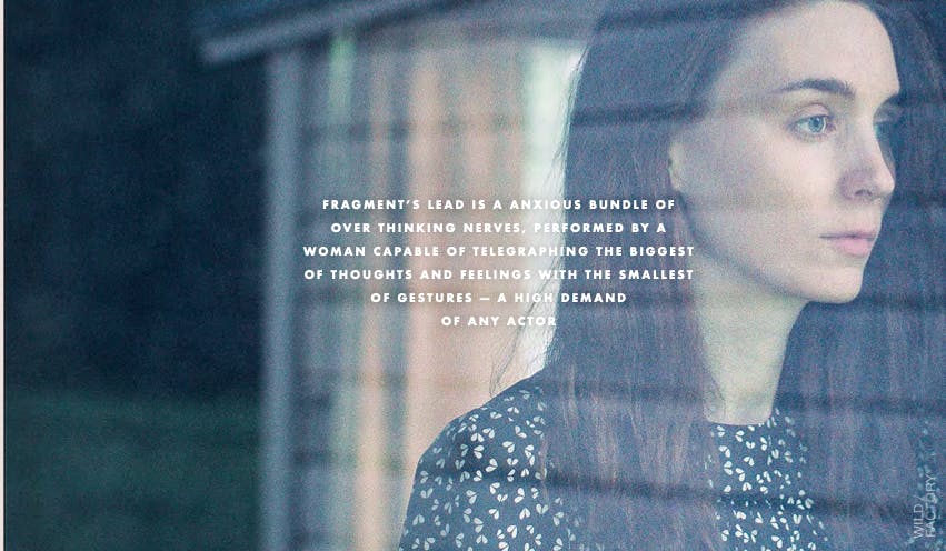 Woman behind glass in a moody campaign image by a creative production agency offering top-tier commercial direction