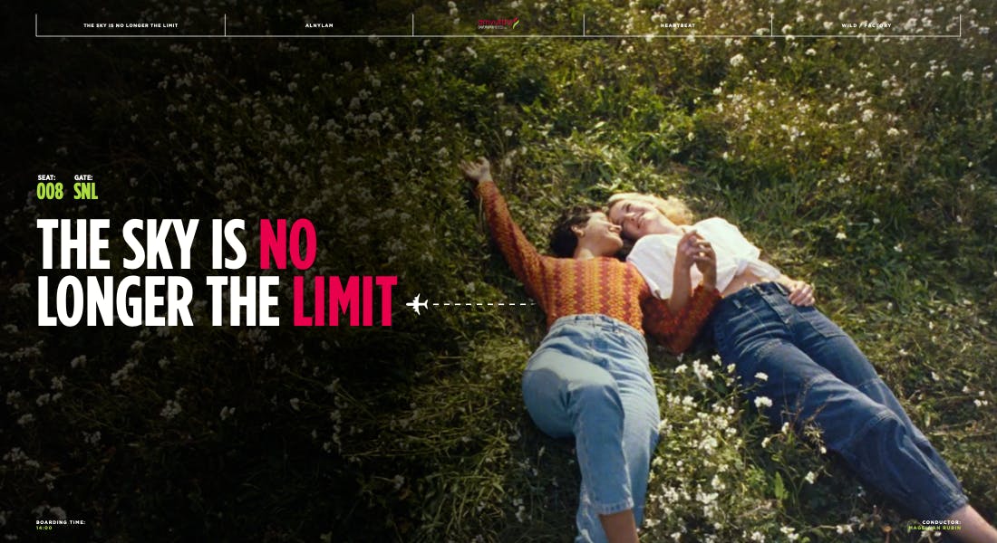 Two people lying in grass beside bold campaign text on a portfolio page for Los Angeles creative directors
