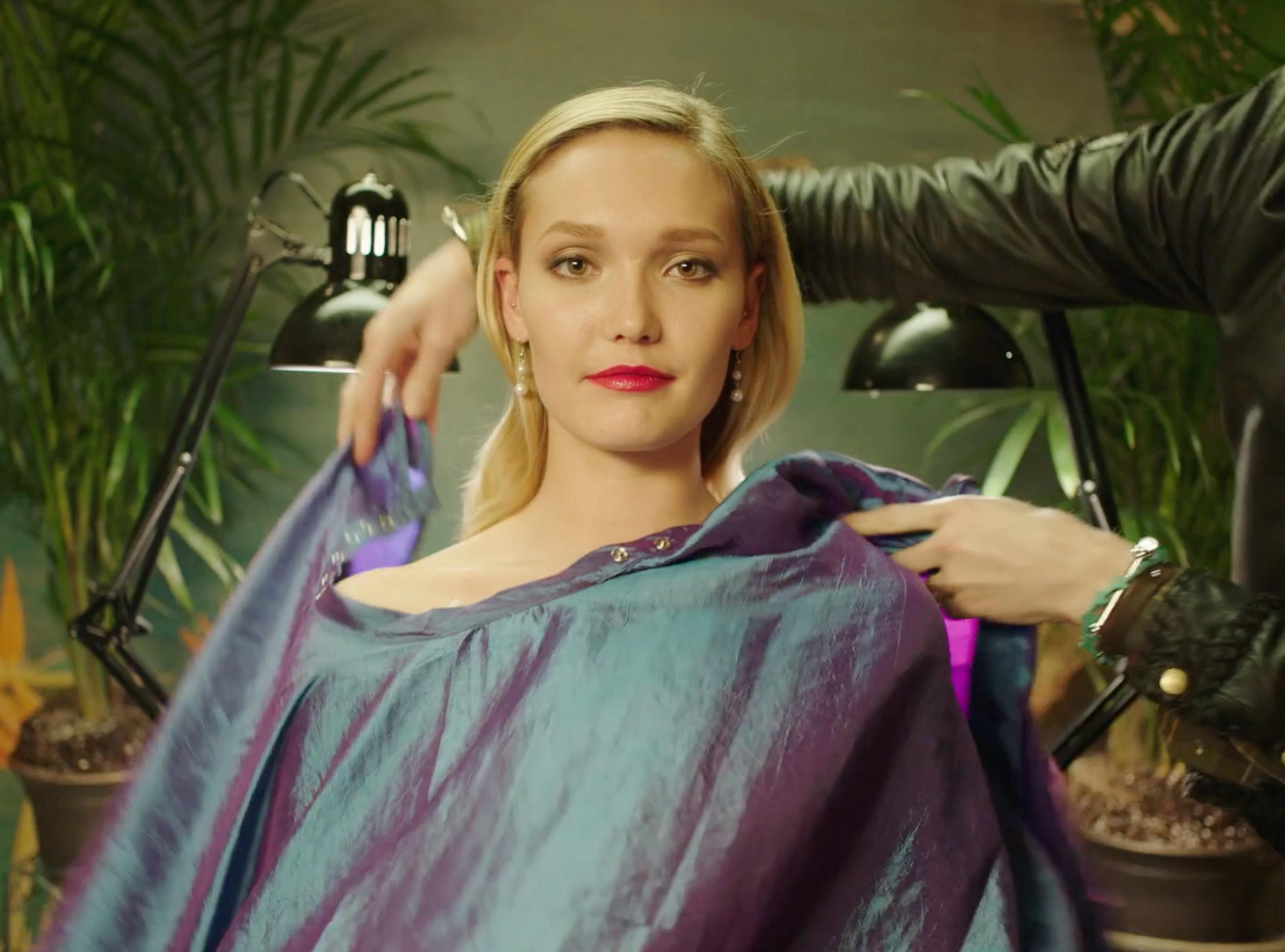 Blonde woman seated in a salon chair during the MICHAA fashion film