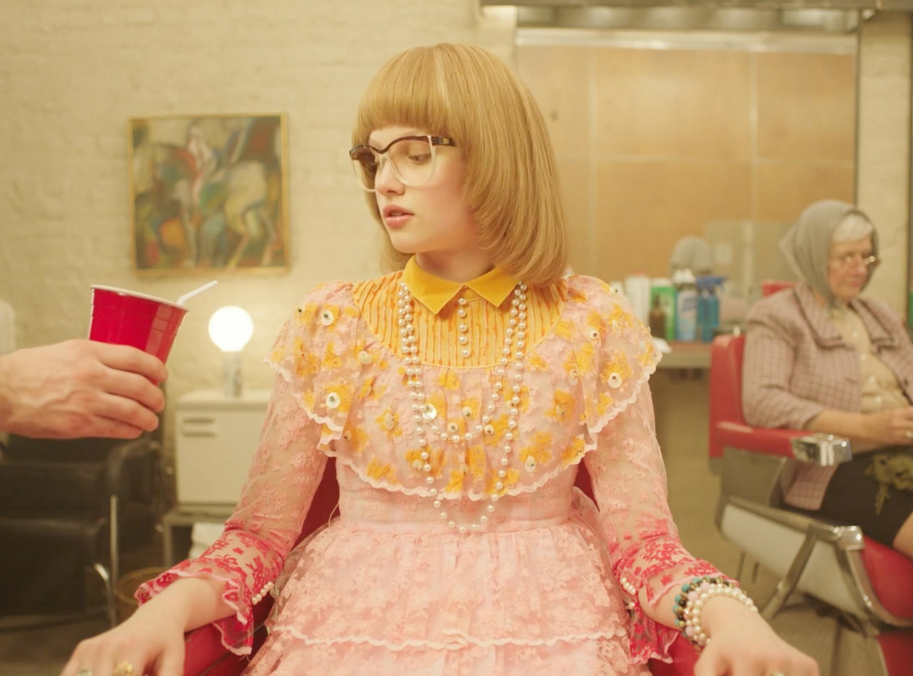 Woman in a yellow dress during the MICHAA fashion campaign saloon scene