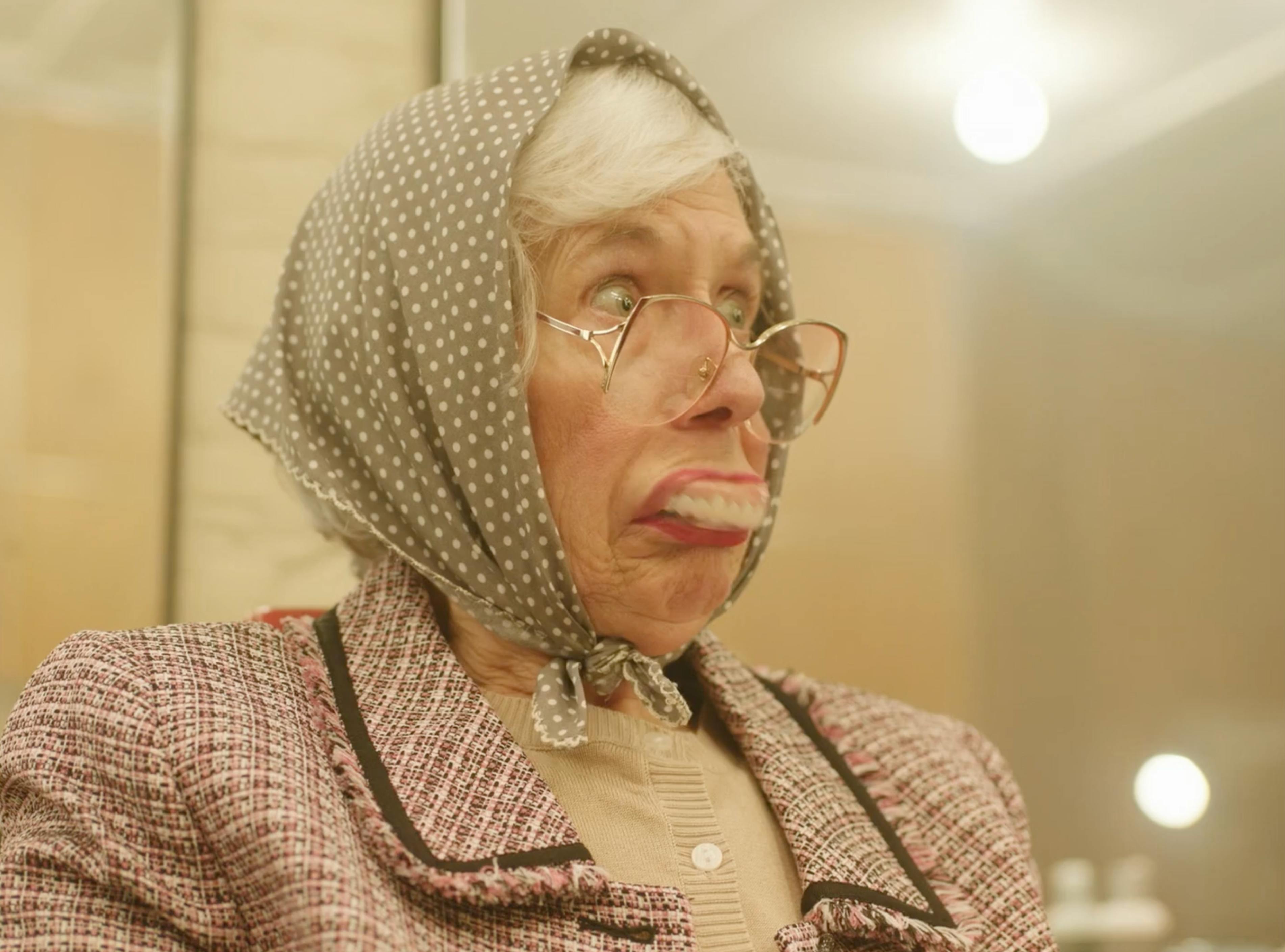 Older woman looking into a salon mirror in MICHAA Women’s Tales fashion film
