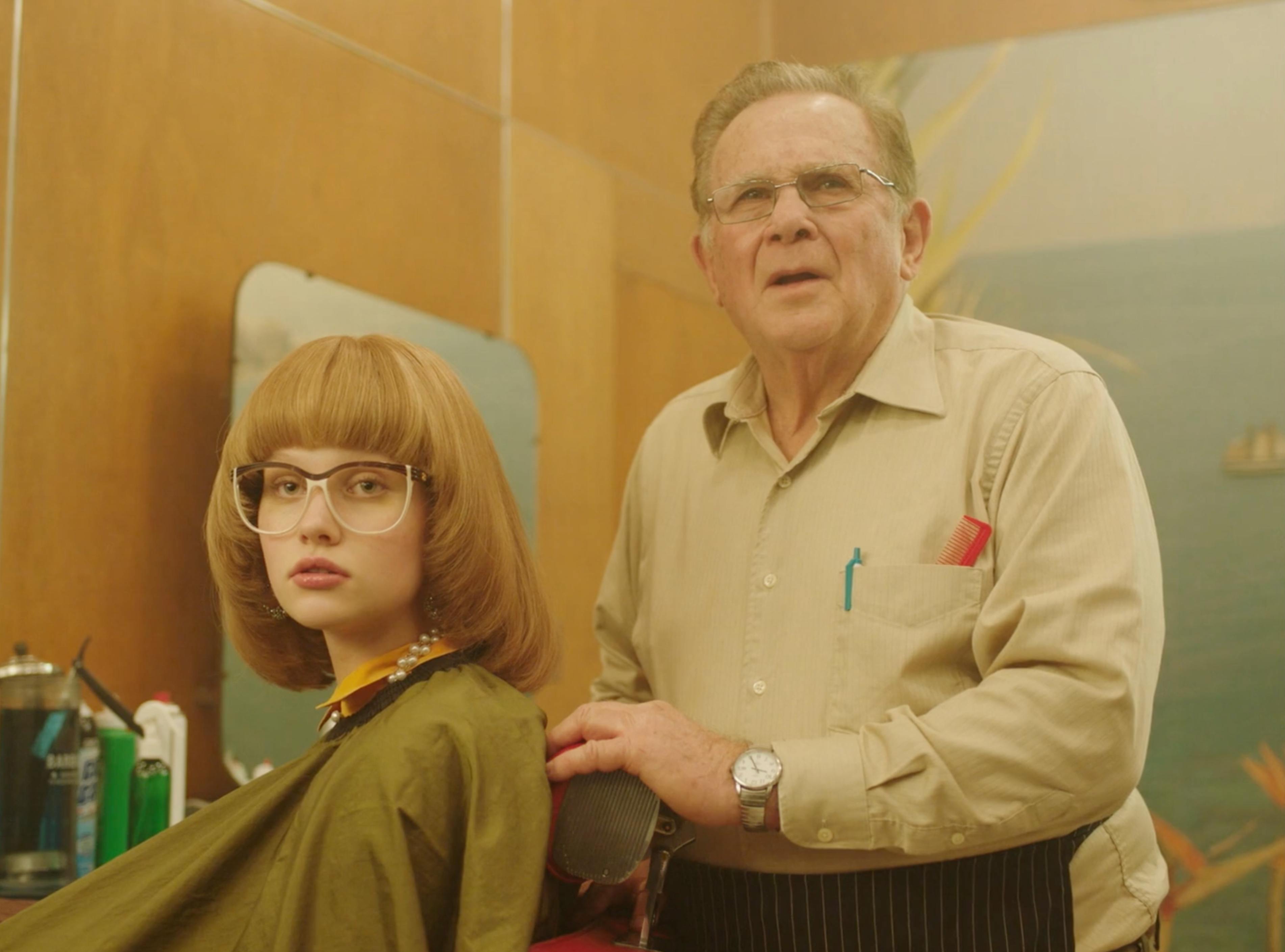 Woman and older man in a salon scene from MICHAA fashion brand film production in New York