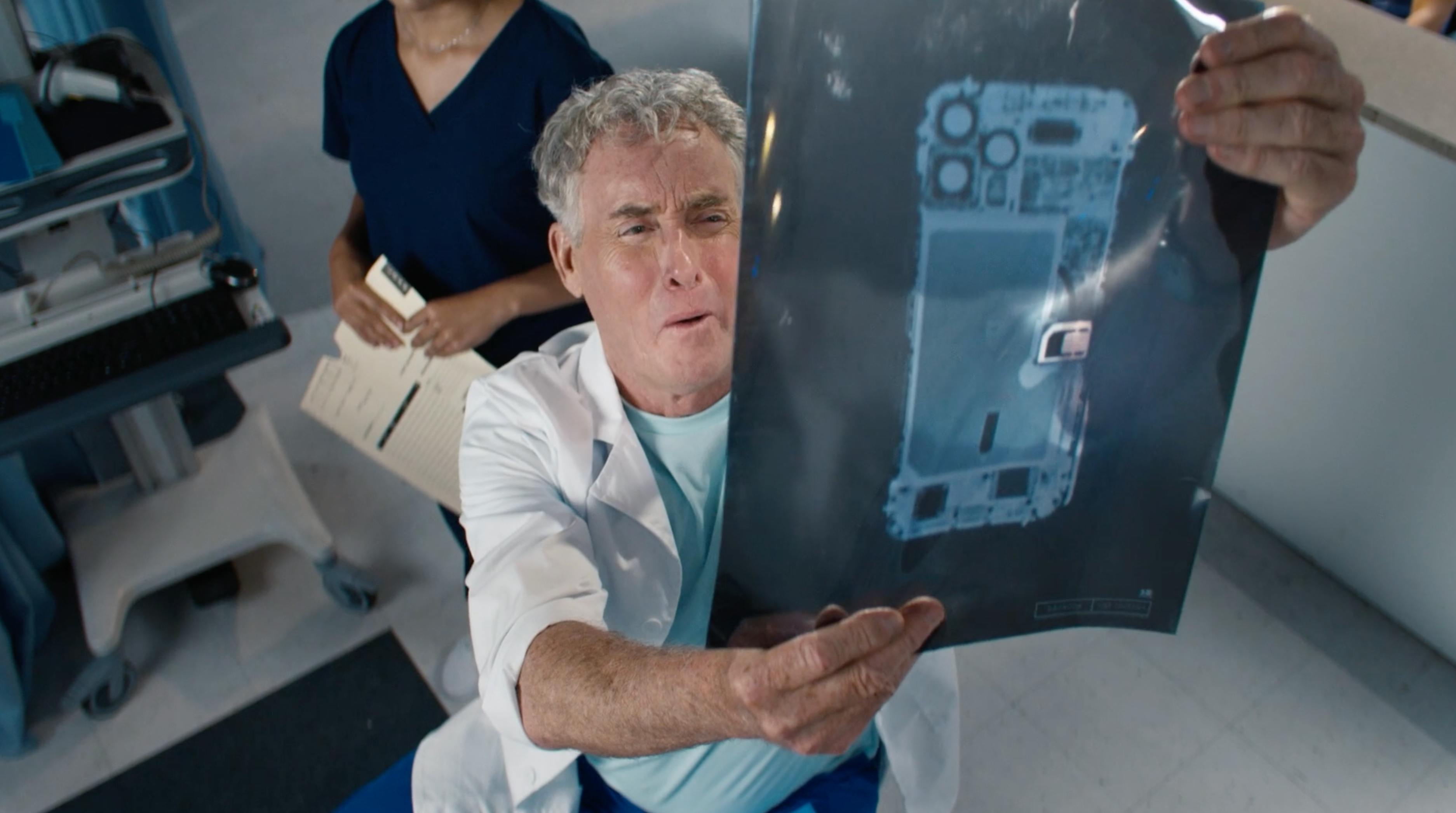 Doctor gesturing during a hospital scene from a telecom brand video production campaign