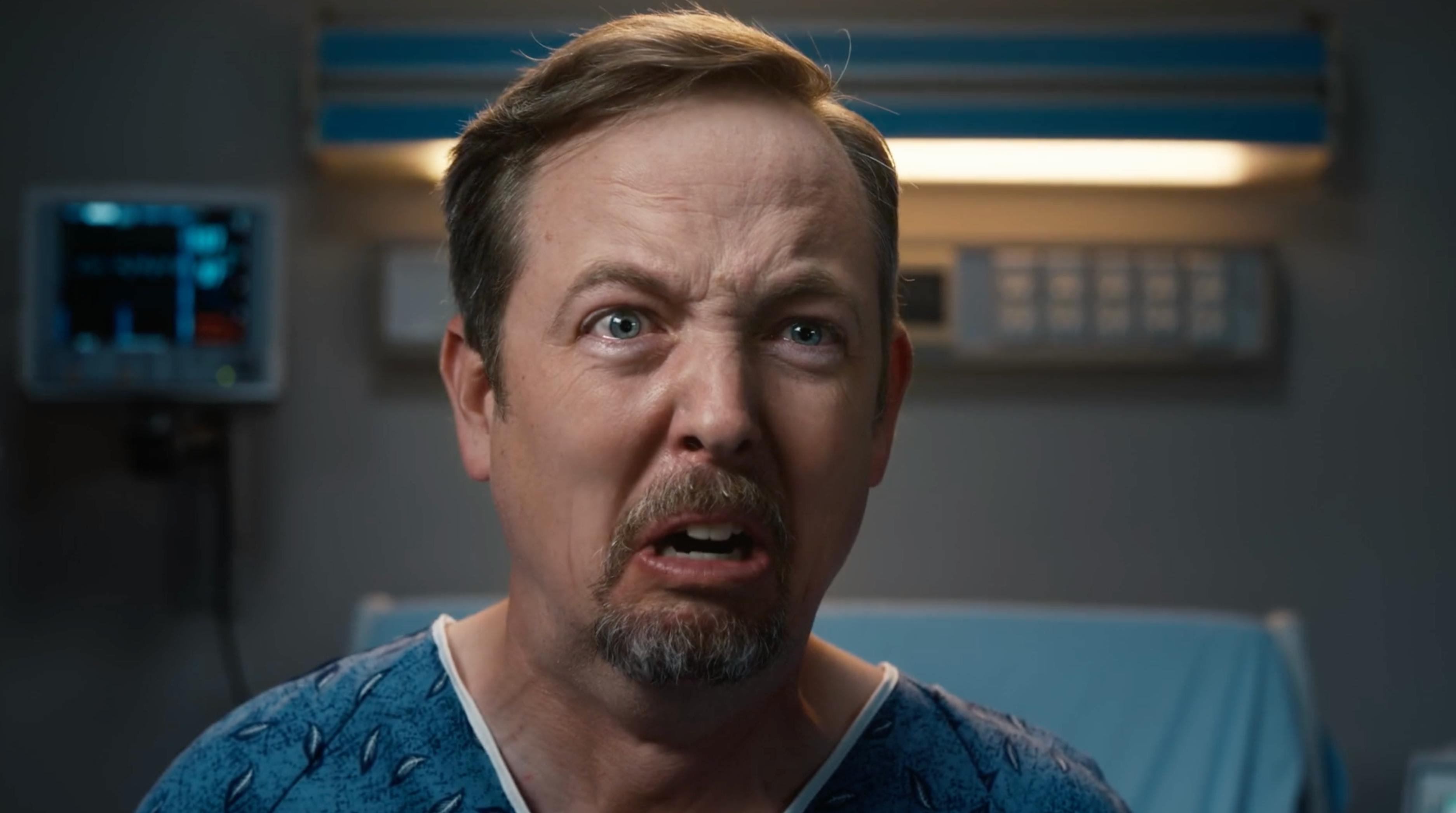 Man in a hospital gown reacting to camera in a celebrity endorsement style telecom campaign