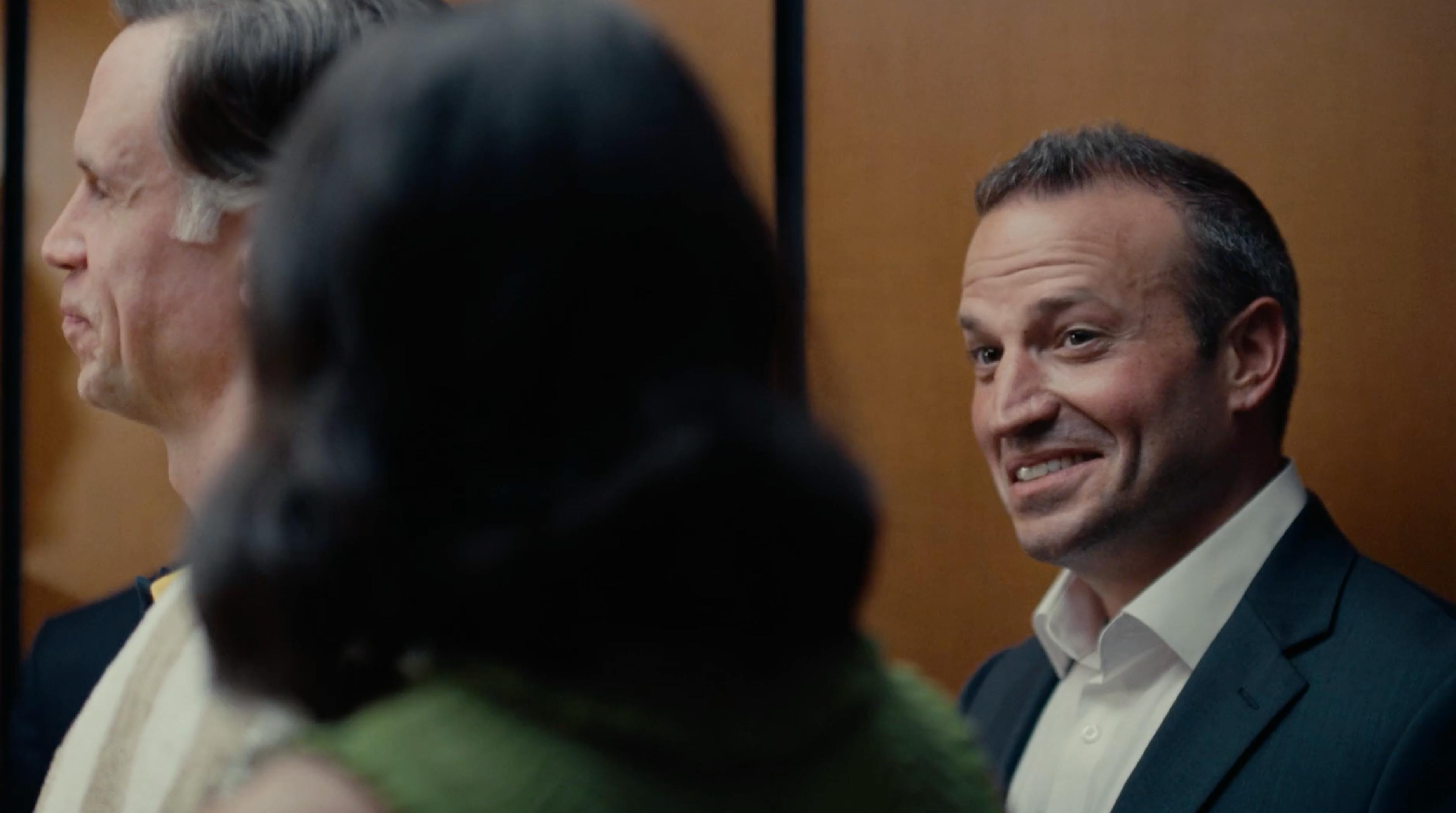 People talking in an elevator lobby during a real estate branded content production campaign