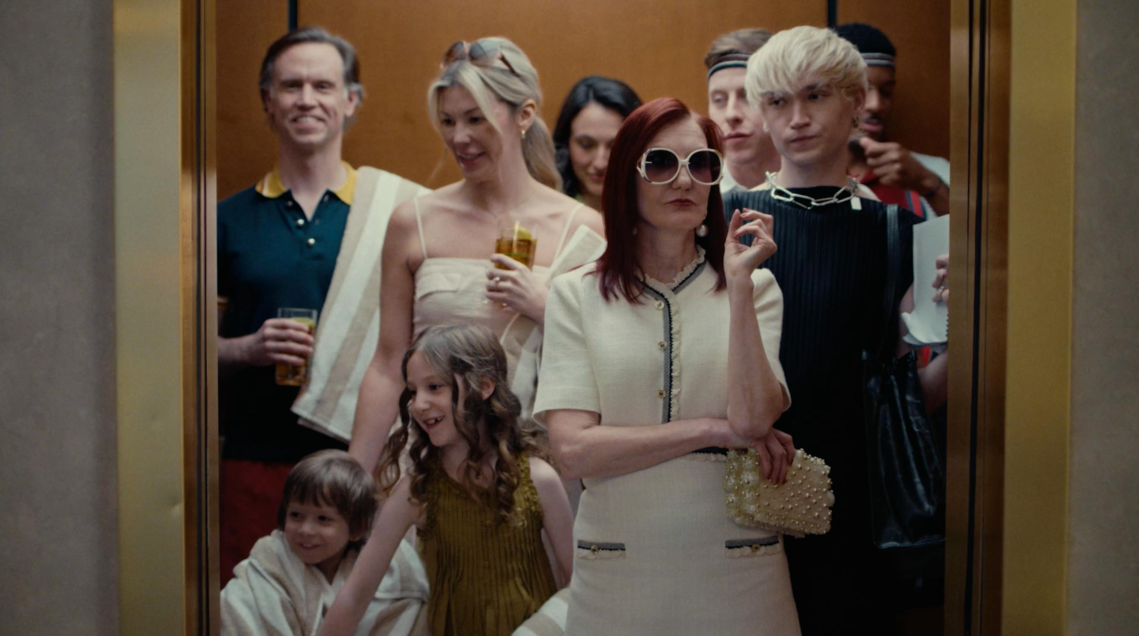 Group of stylish people standing in an elevator for a real estate production partner NYC campaign by a creative video agency