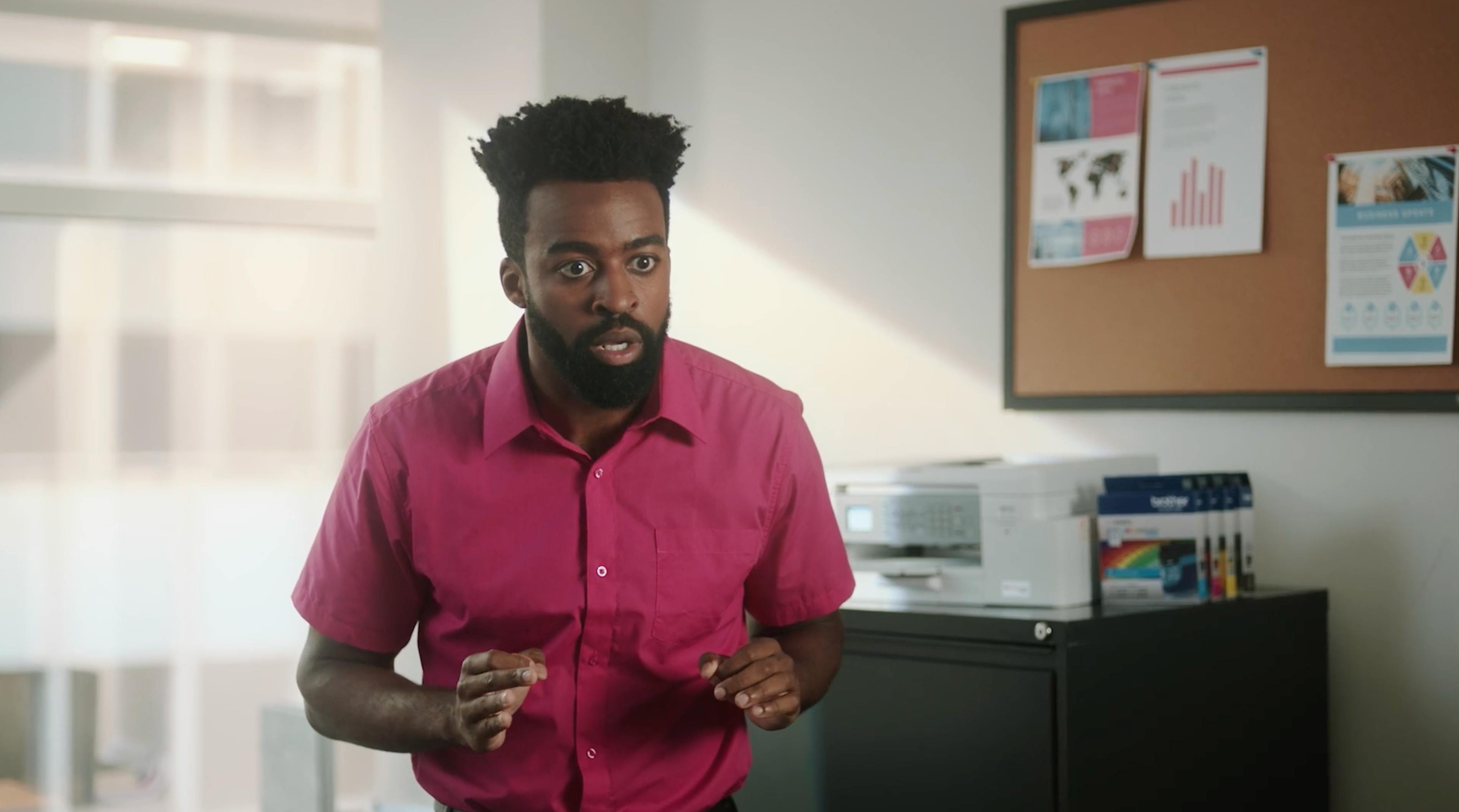 Branded series office comedy scene featuring a magenta-clad character during New York video production.