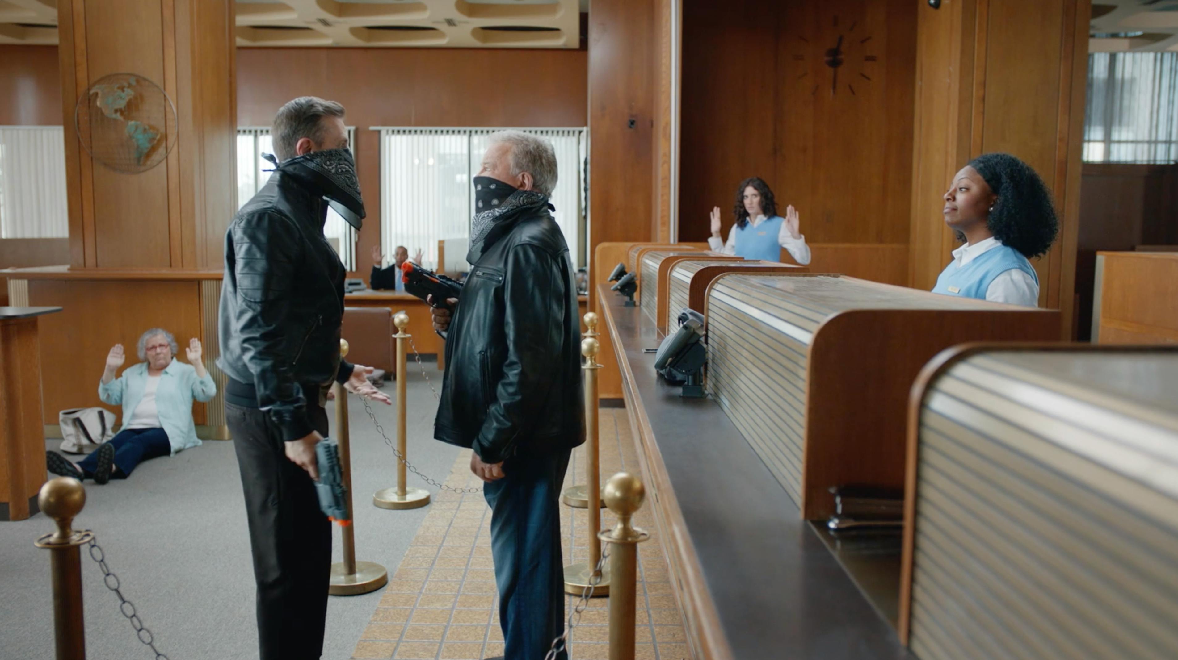 Wide courtroom-style scene with actors facing each other for a branded episodic content video producer local fixer campaign