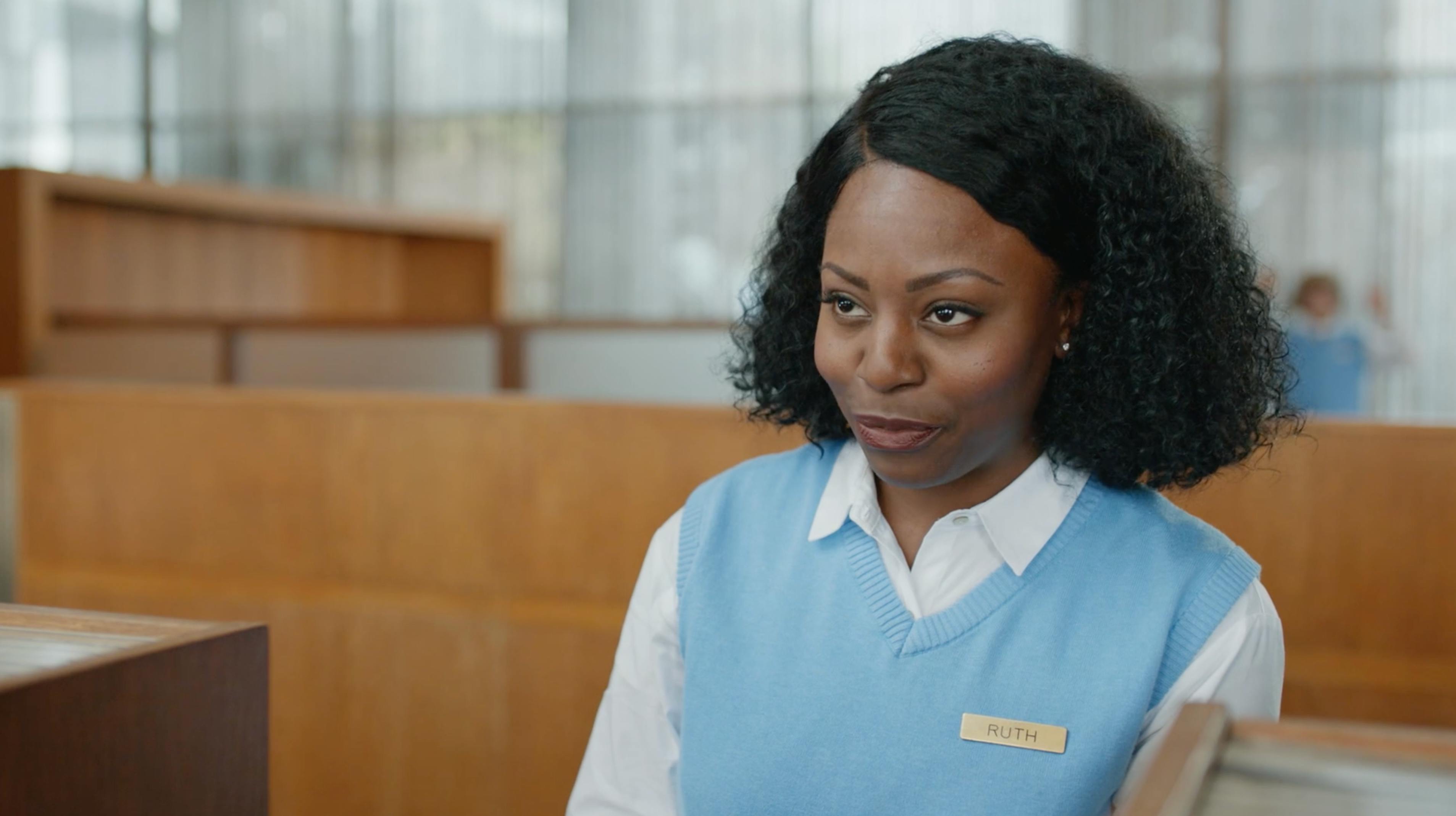 Woman in a blue sweater seated at a desk in branded episodic content video local producer NYC campaign