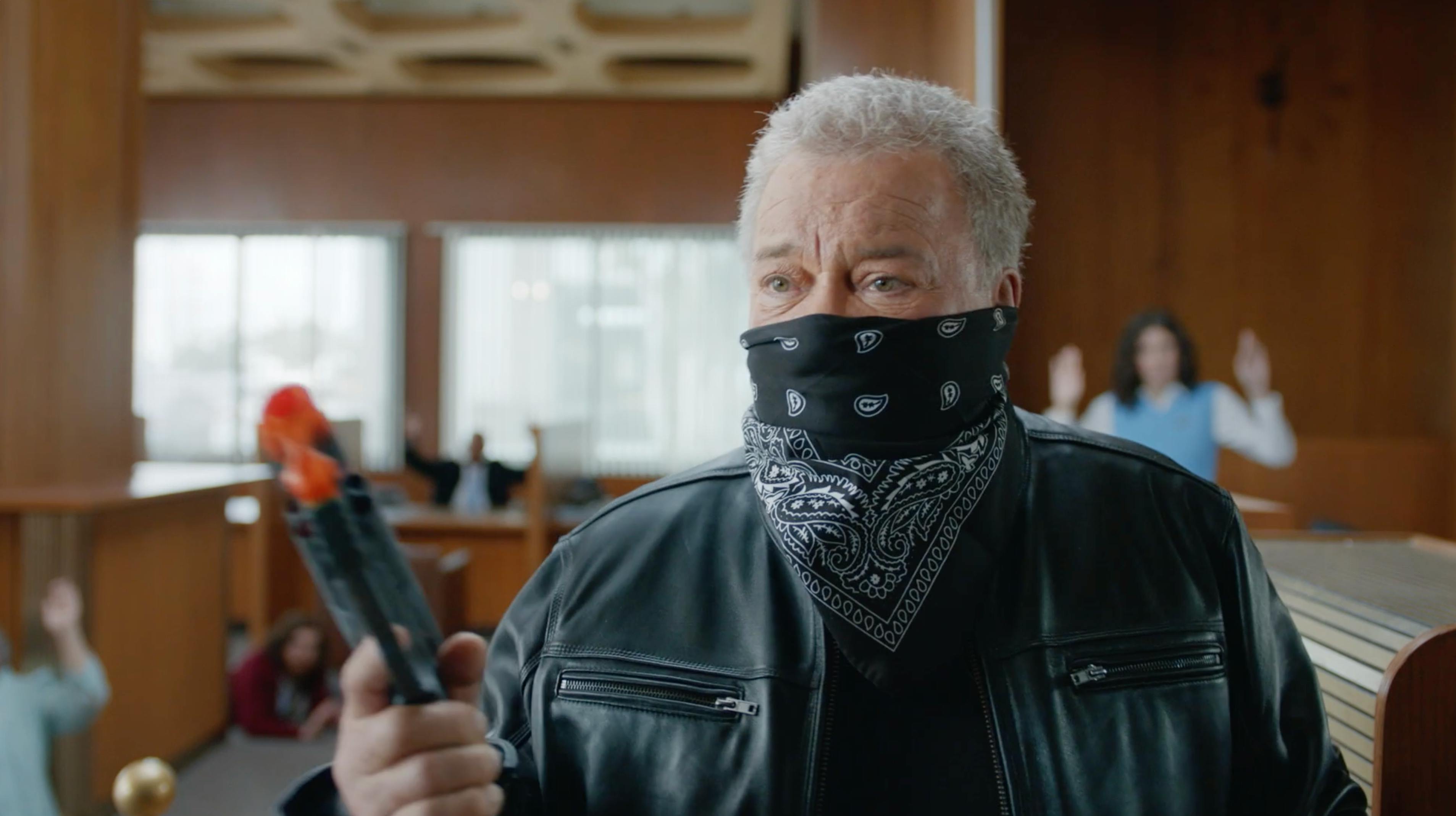 Masked man holding a device in a courtroom set for a branded episodic content video producer CDMX campaign